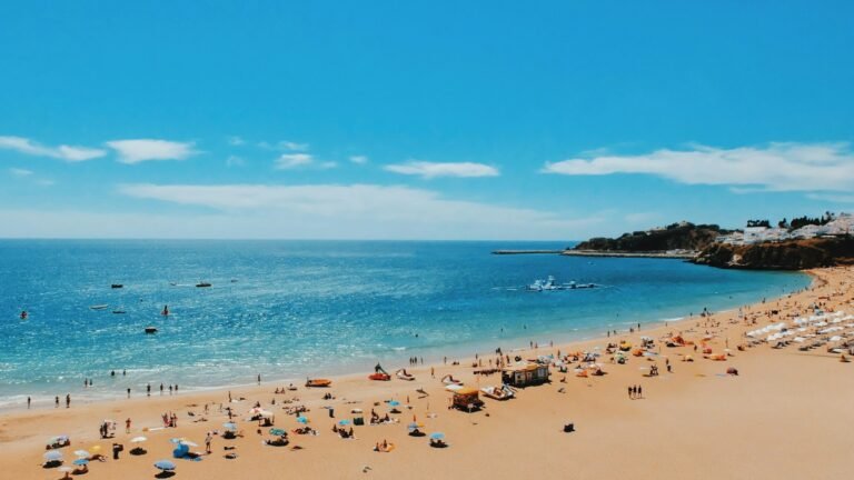 Tourists sunbathing on Albufeira Beach